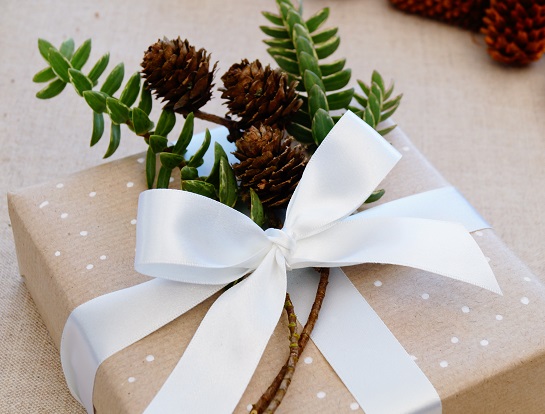 kraft white ribbon foliage and pine cones